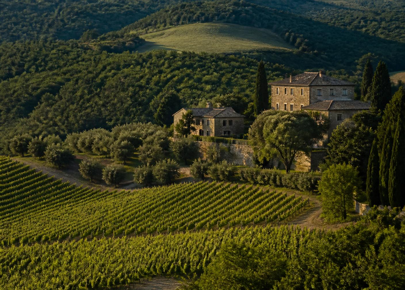 Stone manor house overlooking vineyards and rolling green hills